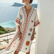Floral V-neck flowy silk summer mini dress for women by FJØRNA, featuring a stylish floral pattern and lightweight fabric.