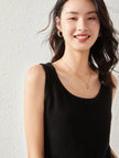 Soft beige FJØRNA women's cashmere top with a relaxed fit, featuring a round neckline and long sleeves.