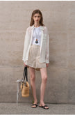 FJØRNA women's linen shirt, lightweight and breathable, shown in a natural relaxed fit with long sleeves and button-front design.