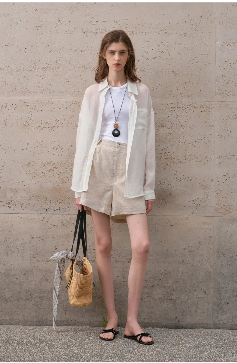 FJØRNA women's linen shirt, lightweight and breathable, shown in a natural relaxed fit with long sleeves and button-front design.