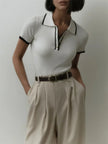FJØRNA women's cotton polo top featuring a classic collar, short sleeves, and a fitted design in soft, breathable fabric.