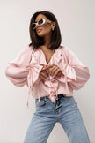 FJØRNA satin women's blouse with ruffle detail, featuring elegant, smooth fabric and stylish design for sophisticated look.