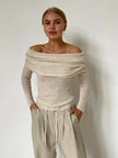 Off-shoulder ribbed knit top for women by FJØRNA, featuring a fitted design and textured fabric in a stylish, casual look.