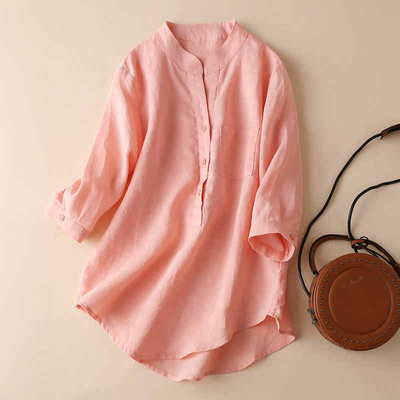 FJØRNA women's summer blouse with V-neck, linen fabric, and wide-leg design, displayed on a hanger with a neutral background.