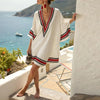FJØRNA women's floral summer mini dress with V-neck, flowy fabric, perfect for warm weather and casual occasions.