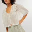 FJØRNA women's cotton blouse with ruffle details, featuring a stylish and comfortable top for women.