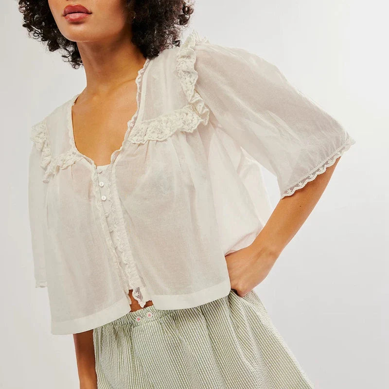 FJØRNA women's cotton blouse with ruffle details, featuring a stylish and comfortable top for women.