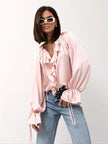 FJØRNA women's satin blouse with ruffle detail, elegant top featuring a smooth fabric finish and feminine design.