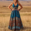 FJØRNA Calisara printed empire waist maxi dress in white with floral patterns, flowing fabric, and elegant design.