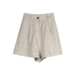 FJØRNA women's high waist linen shorts displayed on a model, showcasing the lightweight, breathable fabric and relaxed fit.