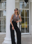 Women's linen blend wide-leg trousers from FJØRNA with high waist and relaxed fit, displayed in a neutral color.
