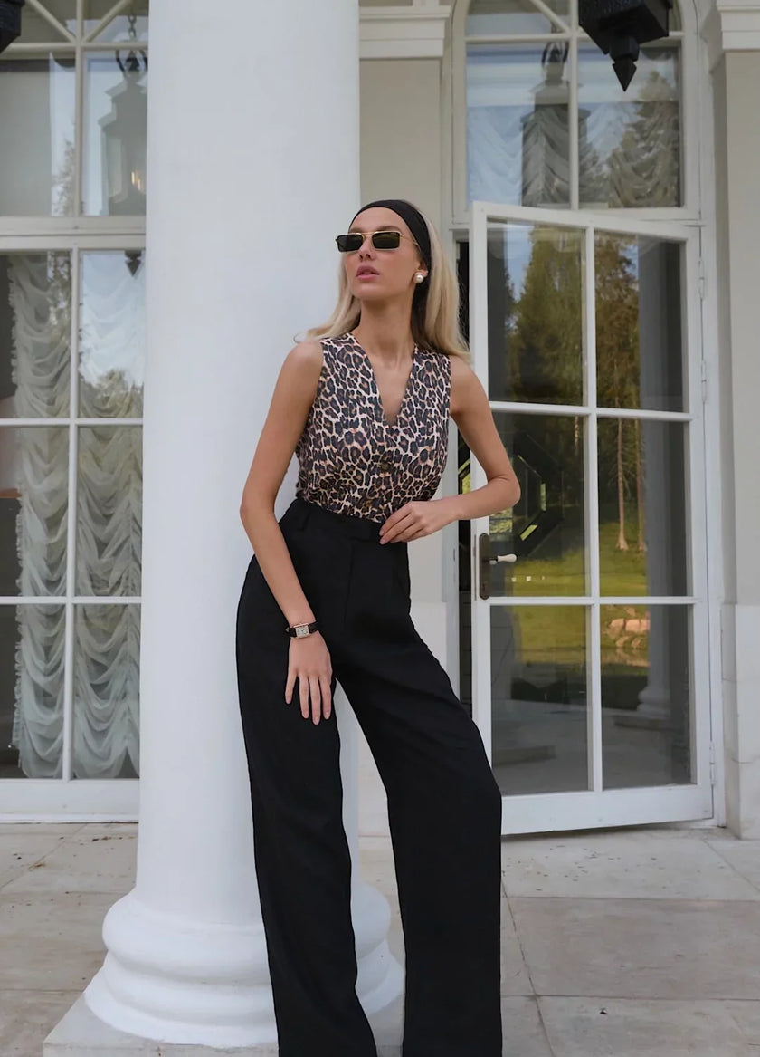 Women's linen blend wide-leg trousers from FJØRNA with high waist and relaxed fit, displayed in a neutral color.