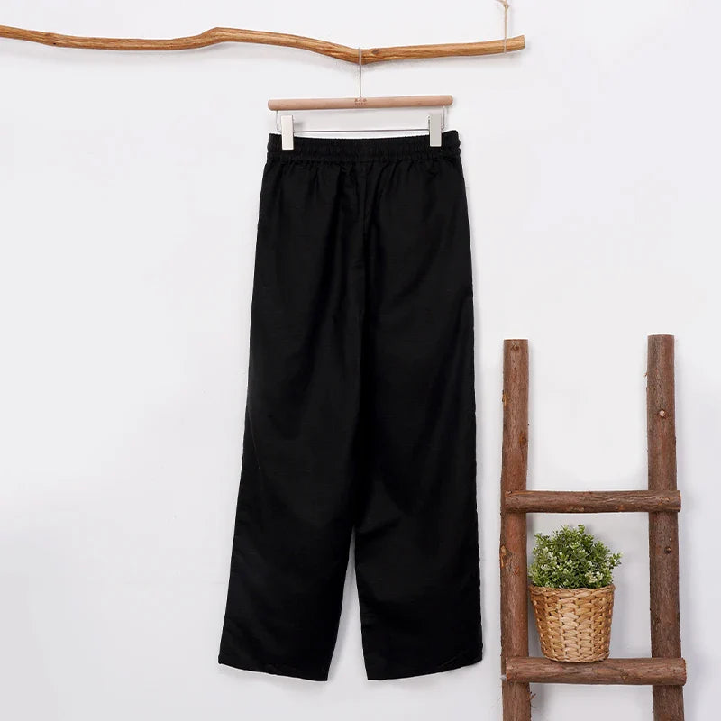 Women’s cotton linen wide-leg trousers by FJØRNA featuring a drawstring pull-on design, relaxed fit, and flowing wide-leg silhouette.