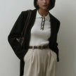 FJØRNA women's cotton polo top featuring a classic collar and short sleeves, displayed on a neutral background.