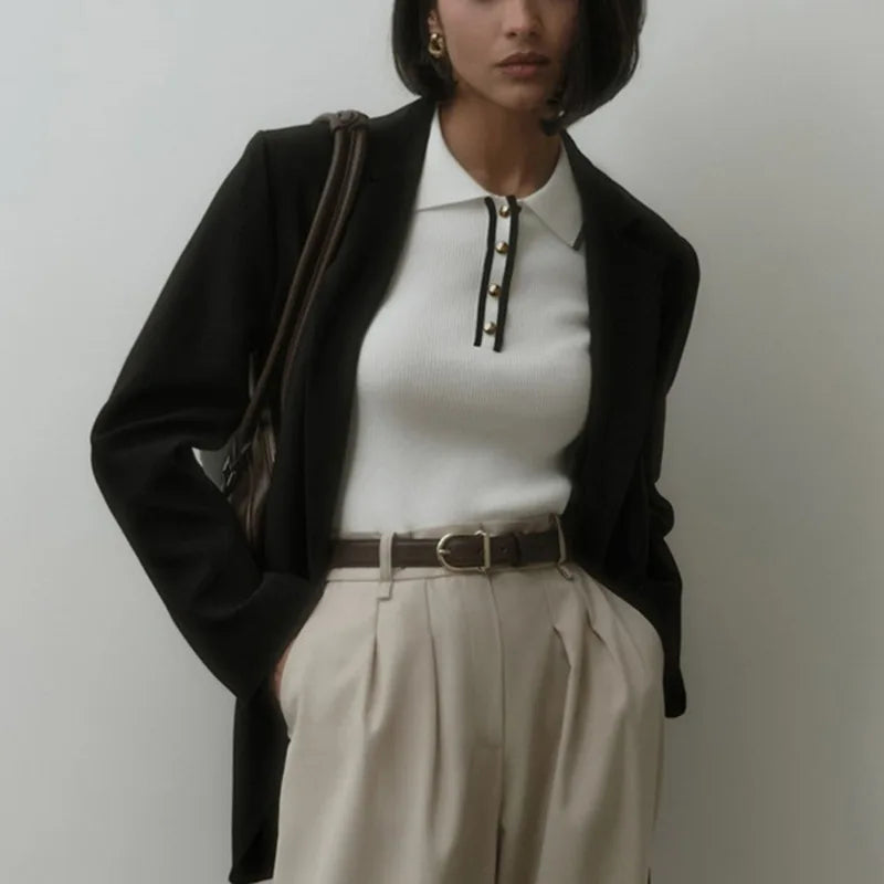 FJØRNA women's cotton polo top featuring a classic collar and short sleeves, displayed on a neutral background.