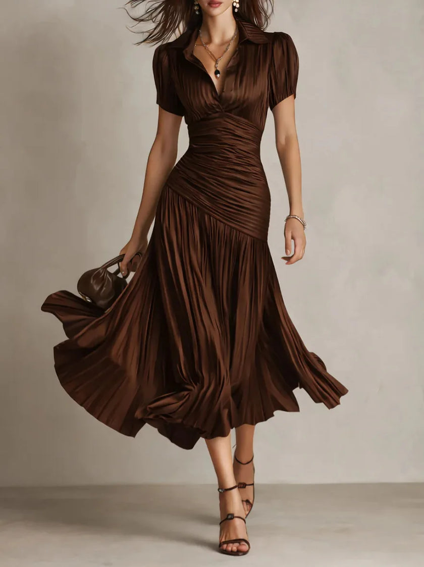 White Zaffira pleated midi dress by FJØRNA, featuring elegant pleats and a classic midi length, showcased on a model.