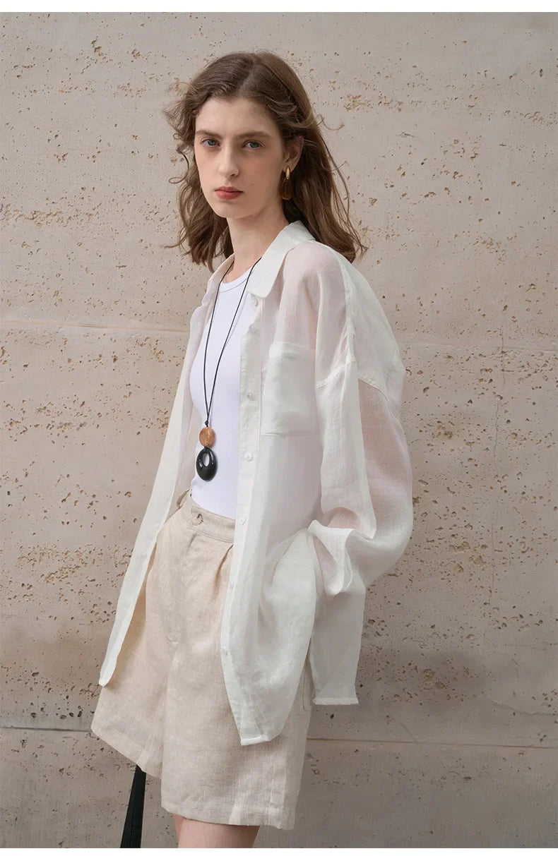 Light beige linen shirt for women by FJØRNA, casual top with long sleeves and button-front design, perfect for warm weather.