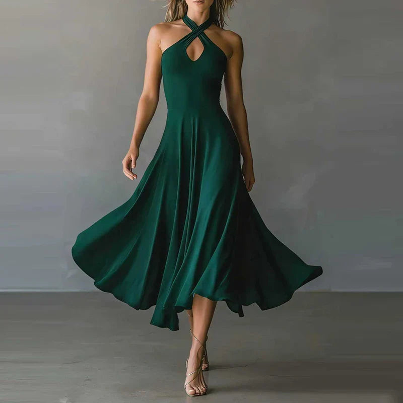 FJØRNA Josie Flowy A-line maxi dress in white, lightweight and elegant, displayed on a hanger against a neutral background.