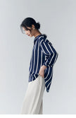 Lacceti Maren Stripe Satin Blouse featuring a classic striped pattern and satin fabric, styled with long sleeves and a relaxed fit.
