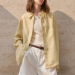 Extra-large linen shirt by FJØRNA featuring spacious pockets, lightweight fabric, and a relaxed fit in natural linen material.