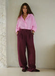 Women’s linen blend wide-leg trousers by FJØRNA with high waist, shown in a relaxed fit and neutral color.
