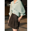 Women’s high waist linen shorts by FJØRNA, showcasing lightweight, breathable fabric and a relaxed fit for warm weather.