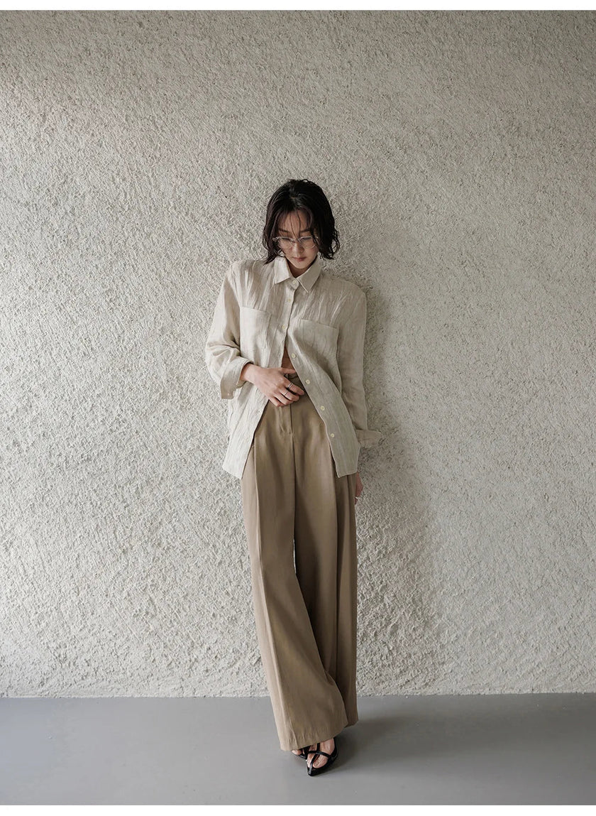FJØRNA women's linen shirt with pleated design, featuring a relaxed fit and natural fabric texture, ideal for casual and chic looks.
