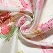 White satin floral pencil maxi dress by FJØRNA with a fitted silhouette and elegant floral pattern.