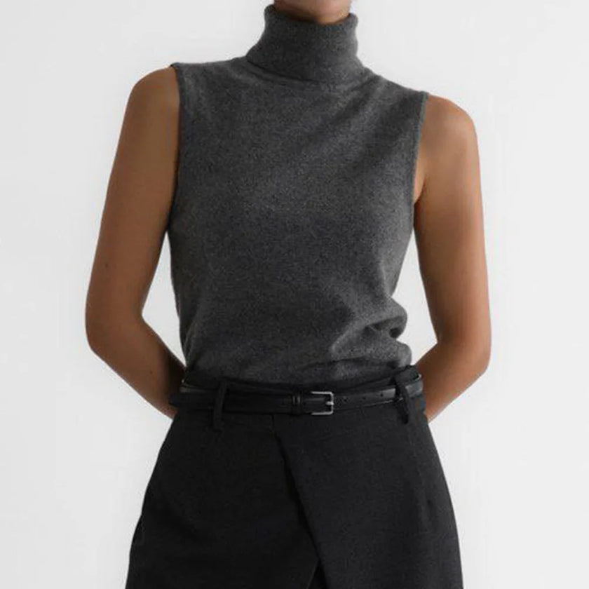 FJØRNA women's sleeveless wool vest, soft knit top with a fitted silhouette and ribbed neckline, worn layered over a shirt.