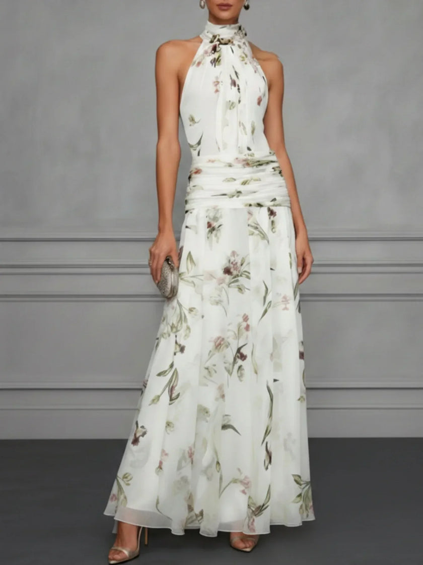 FJØRNA Jasmine floral halter wedding guest dress with a fitted bodice and flowy skirt, featuring a vibrant floral pattern.