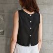 FJØRNA women's linen crop top with short sleeves and V-neck, displayed on a hanger against a white background.
