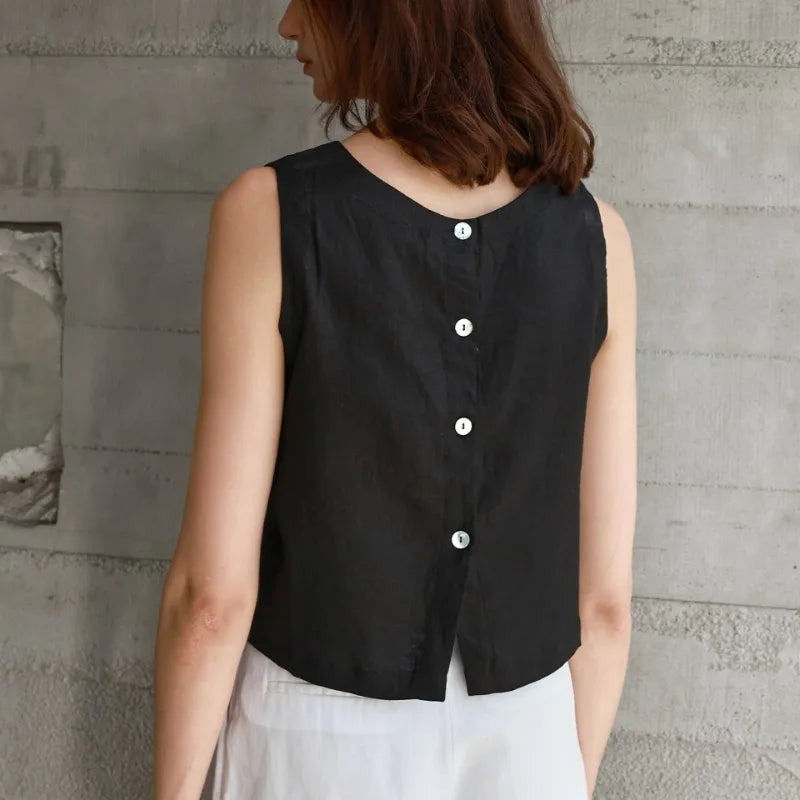 FJØRNA women's linen crop top with short sleeves and V-neck, displayed on a hanger against a white background.