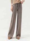 FJØRNA women's merino wool wide-leg high-waist trousers, stylish and comfortable pants, shown in a natural pose.