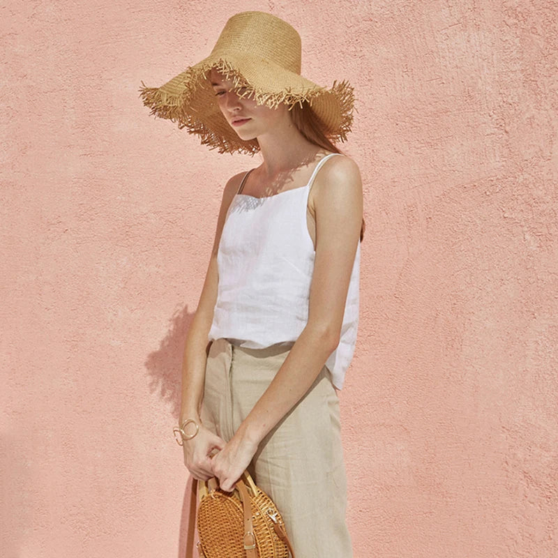 FJØRNA satin-trimmed linen cami top in light neutral color, featuring delicate satin accents and a relaxed fit.