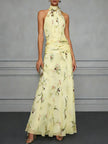 Jasmine floral halter wedding guest dress by FJØRNA with a flowy silhouette and floral pattern, perfect for summer events.