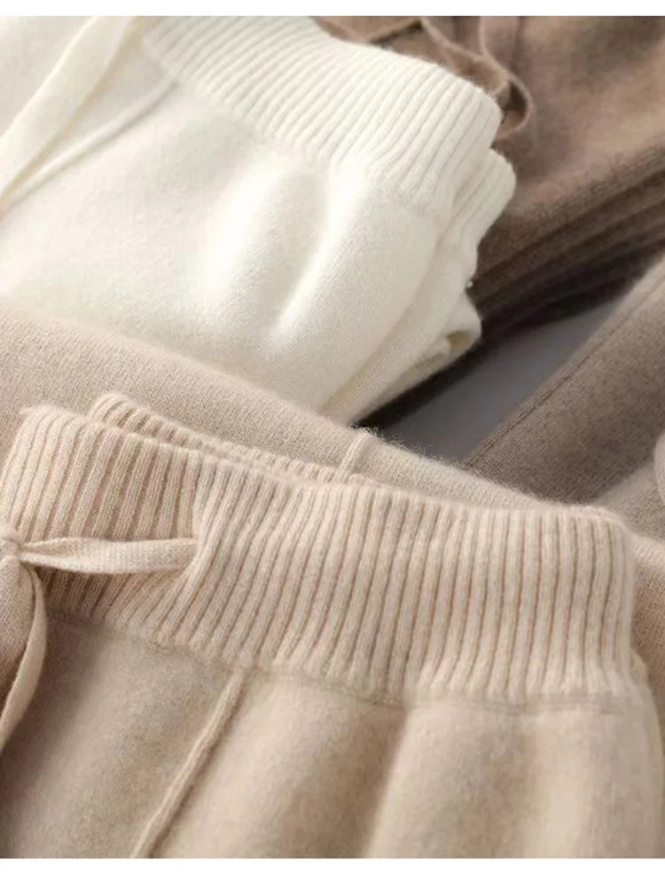 FJØRNA women's merino wool wide-leg high-waist trousers, close-up of soft, textured fabric and tailored fit.