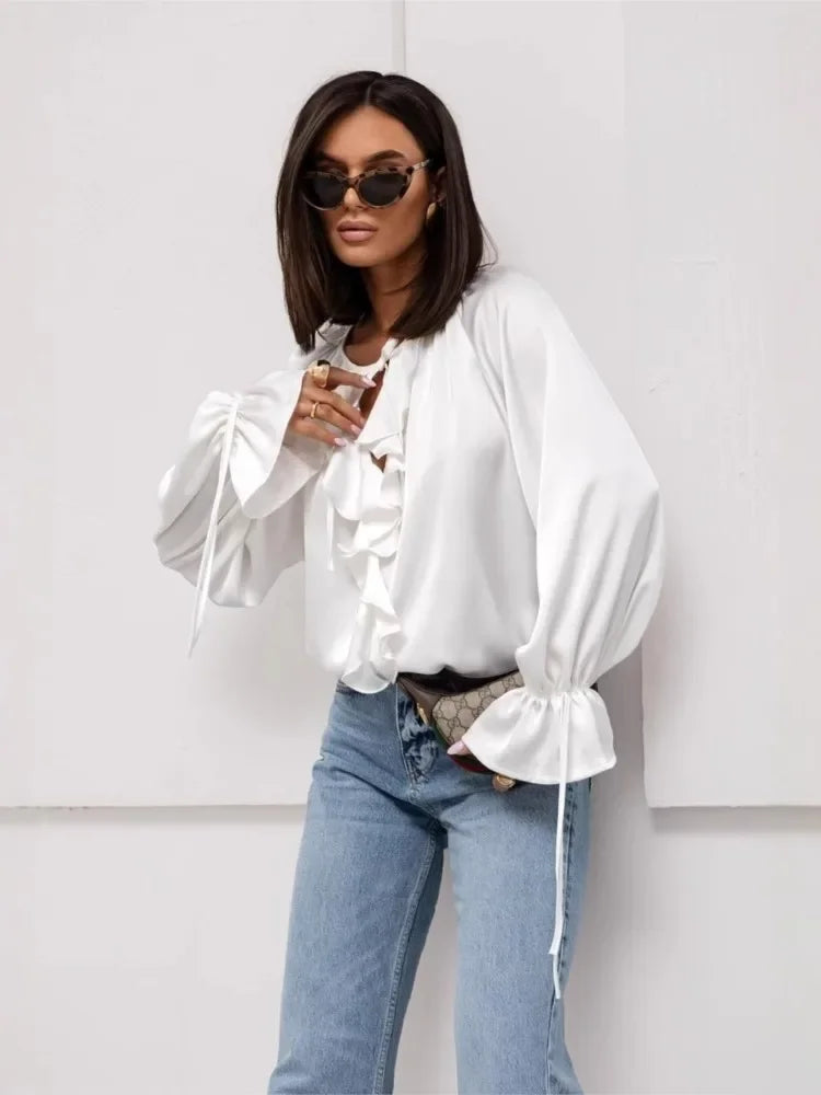 FJØRNA satin blouse for women with ruffle detail, shown in a stylish, elegant top with smooth fabric and feminine design.