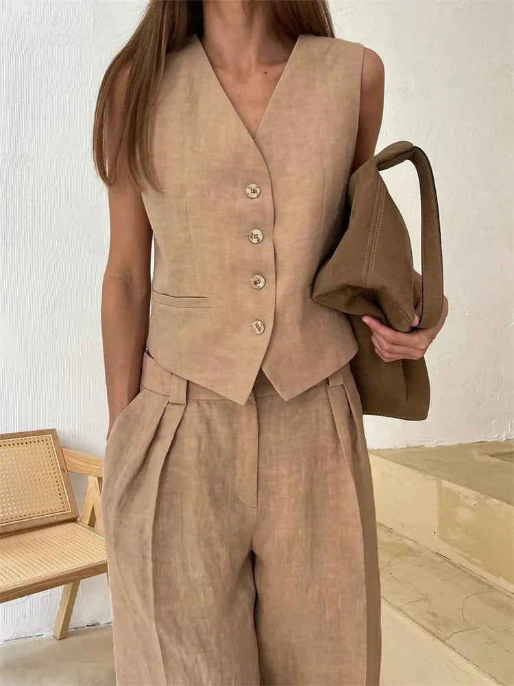 FJØRNA women's linen wide-leg trousers, part of co-ord set, shown in natural fabric and relaxed fit style.