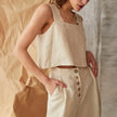 FJØRNA square neck linen cropped tank top displayed on a model, showcasing its stylish square neckline and lightweight fabric