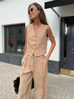FJØRNA women's linen wide-leg trousers, part of co-ord set, showing relaxed fit and natural beige color in the image.