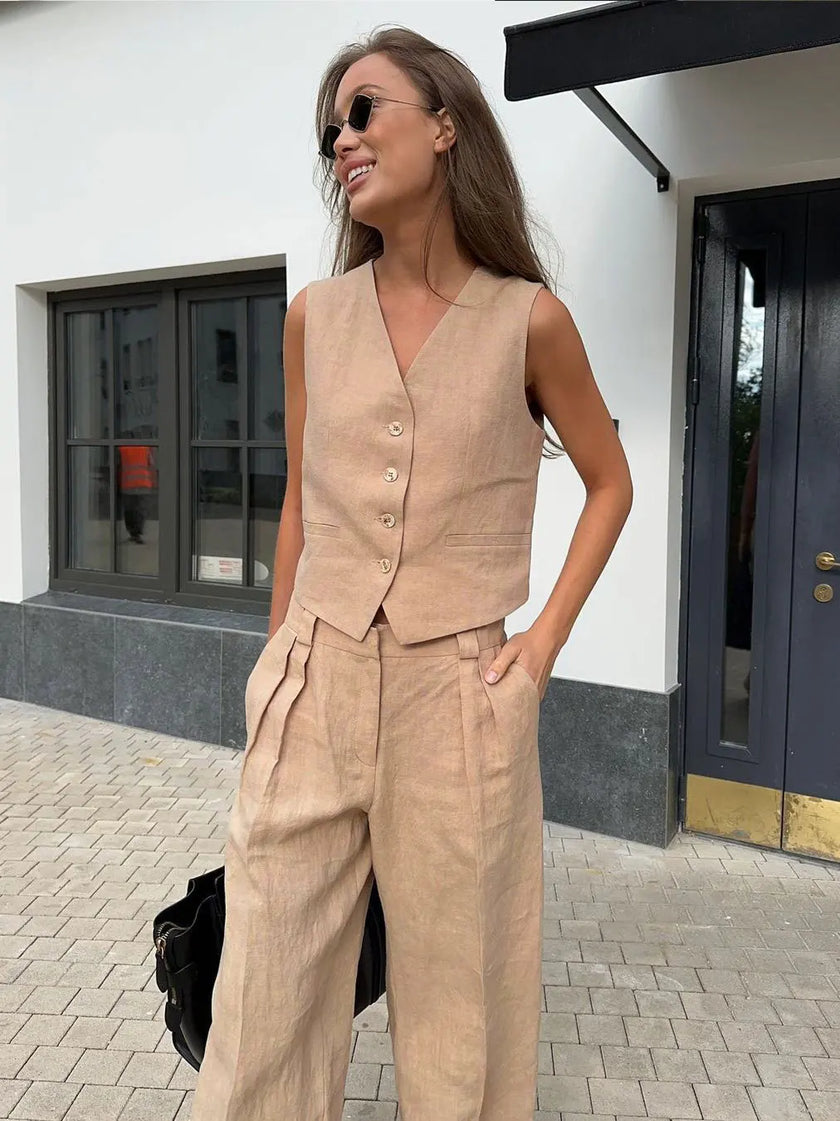 FJØRNA women's linen wide-leg trousers, part of co-ord set, showing relaxed fit and natural beige color in the image.