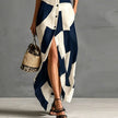 FJØRNA Victoria printed white maxi dress with button-down front and flowing silhouette, perfect for casual or summer wear.