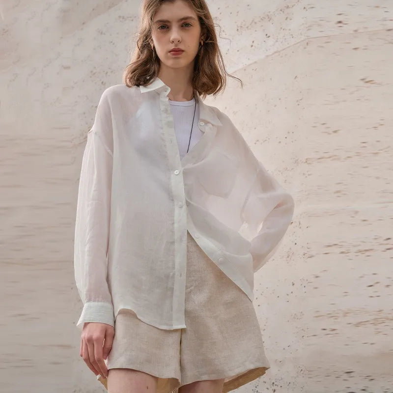 Light beige linen shirt for women by FJØRNA, featuring a relaxed fit and classic collar, perfect for casual or office wear.
