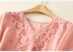 FJØRNA women's cotton V-neck blouse, soft and lightweight top with a relaxed fit, shown in a natural fabric drape.