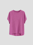 FJØRNA oversized tee with rolled cuffs, featuring a relaxed fit and soft fabric, displayed on a hanger against a neutral background.