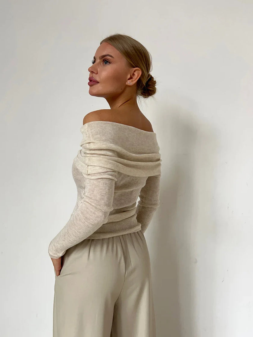 Off-shoulder ribbed knit top for women by FJØRNA, featuring a fitted design and textured fabric in neutral color.