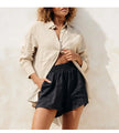 FJØRNA extra-large linen shirt with spacious pockets, showing a relaxed fit and natural fabric texture on a neutral background.
