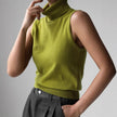 FJØRNA women's sleeveless wool vest, stylish and cozy top, shown in a natural beige color, perfect for layered winter outfits.