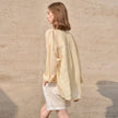 FJØRNA linen shirt for women, lightweight and breathable top with a relaxed fit, featuring a collar and button closure.