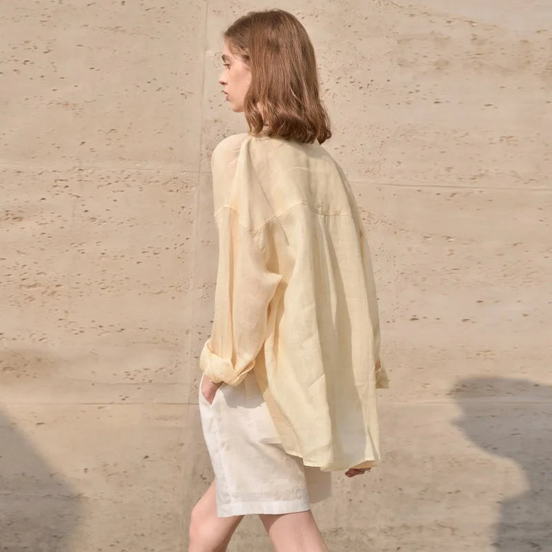 FJØRNA linen shirt for women, lightweight and breathable top with a relaxed fit, featuring a collar and button closure.